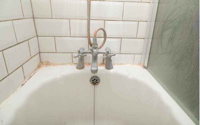 For a piece on bathtub refinishing, an old tub that is gross and needs to be replaced has an old faucet on it too