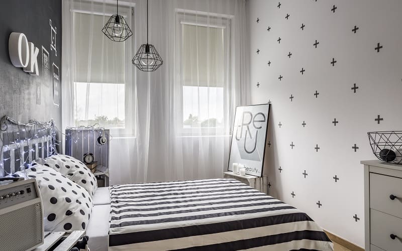 Small cozy bedroom with black and white decorations