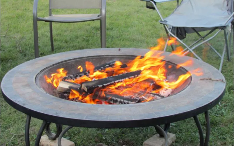 Simple metal fire pit idea with a giant flat saucer with a metal bowl in the middle to burn wood