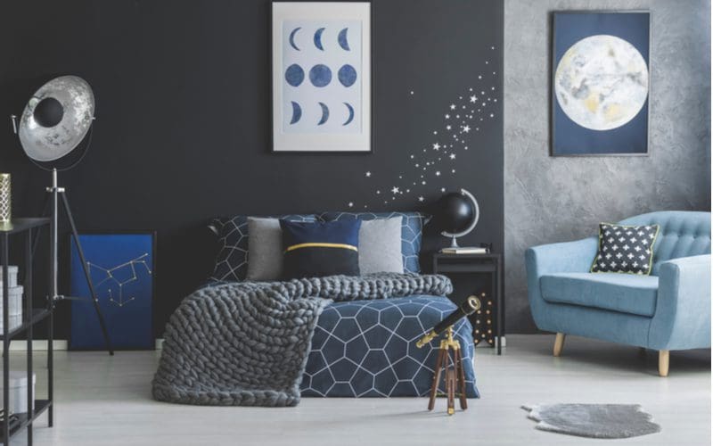 Blue-grey bedroom idea featuring star-themed decor and bedding