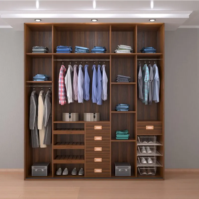 Men's bedroom idea with an open wardrobe from which hang shirts and on which sit shoes