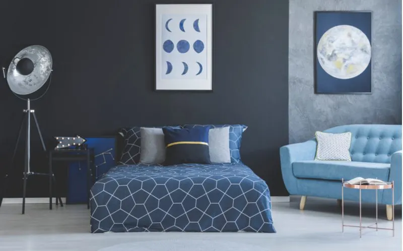 Modern bedroom with planetary art and masculine bedding with a constellation-themed bedsheet set