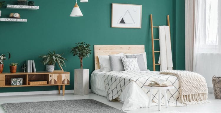 Featured image for a piece titled Aesthetic Bedroom Ideas featuring a hunter green wall with natural wood furniture and grey marble floors and shelves