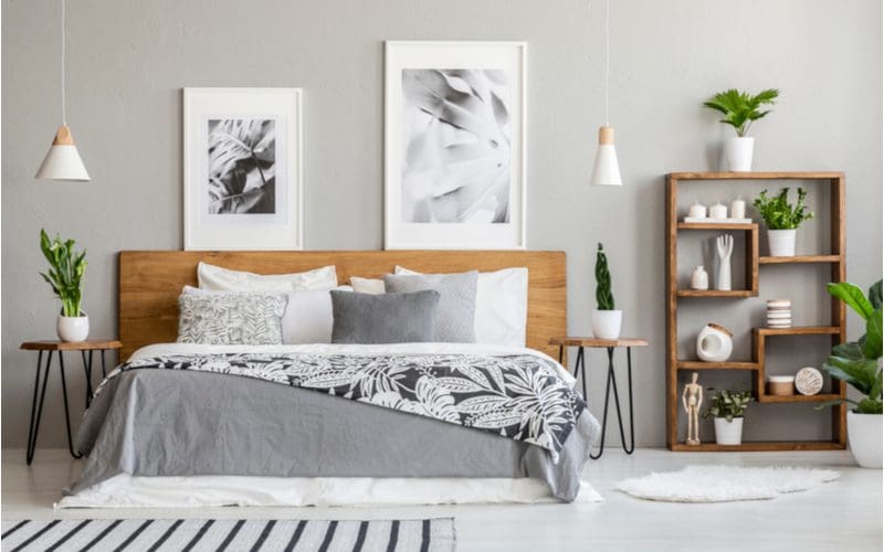 Grey bedroom idea that uses natural wood and greenery in a boho-style aesthetic