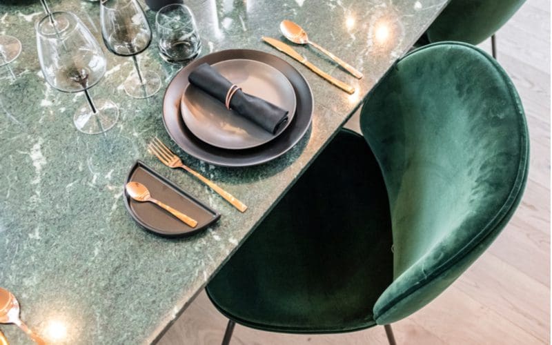 Faux suede, one of the best fabric types for dining room chairs, shown from above with the chair pushed up against a dining room table