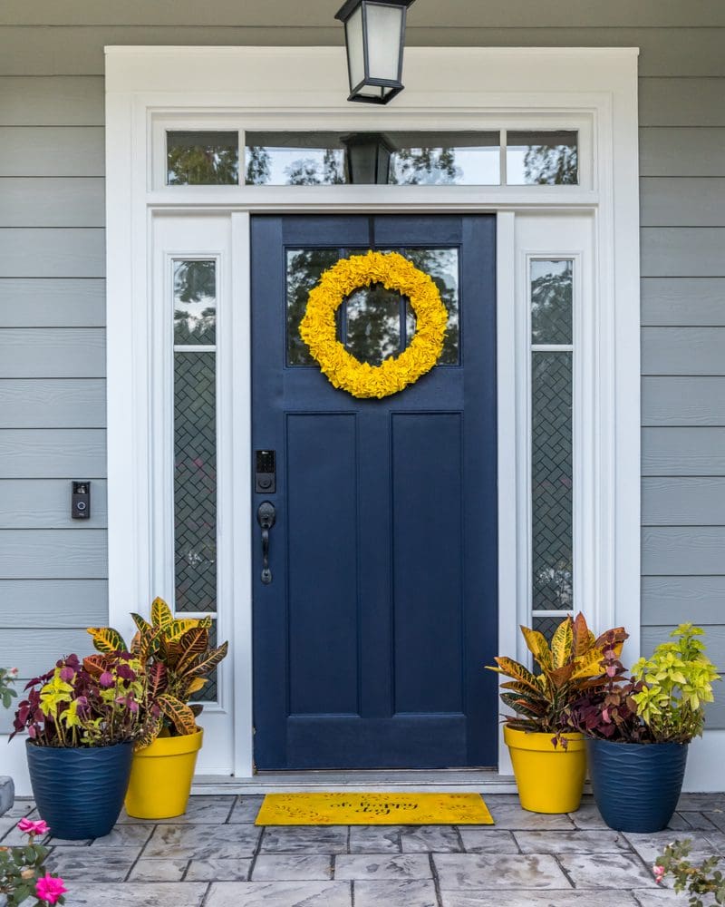 For a piece on the Front door colors for gray houses, a blue door nestled between white trim and gray siding