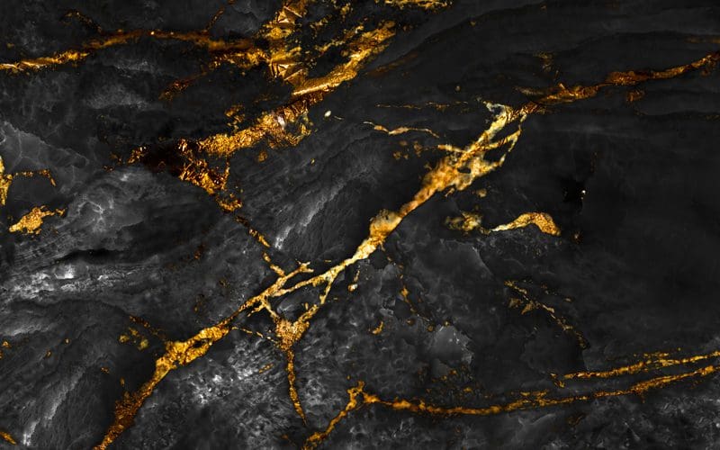 Close up of a piece of black and gold marble