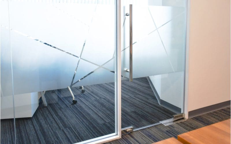To illustrate how to cover glass doors with window film, a big double door covered with a patterned window film