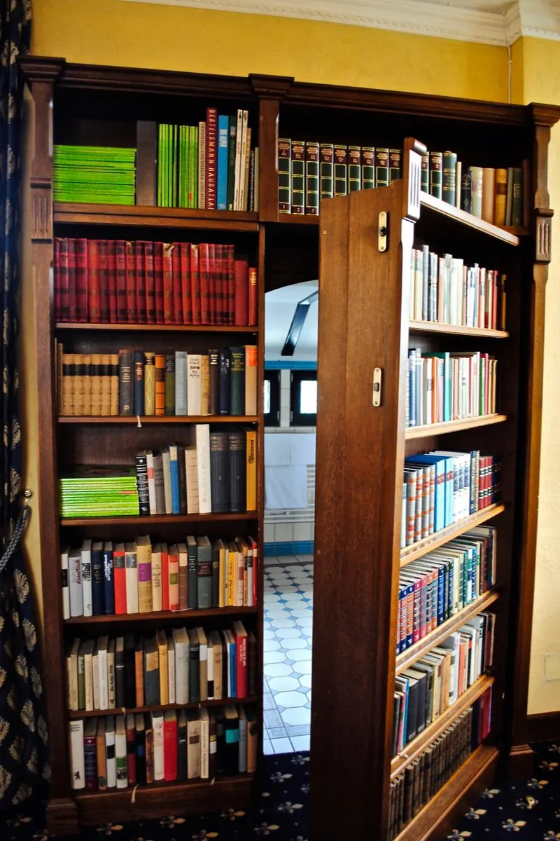 Image for a piece on closet door ideas featuring bookcase doors opening to a secret room