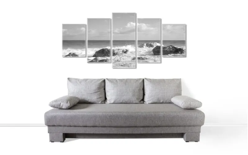 Panoramic five-panel black and white photo set of a beach with waves crashing on rocks as an idea for wall décor above the couch