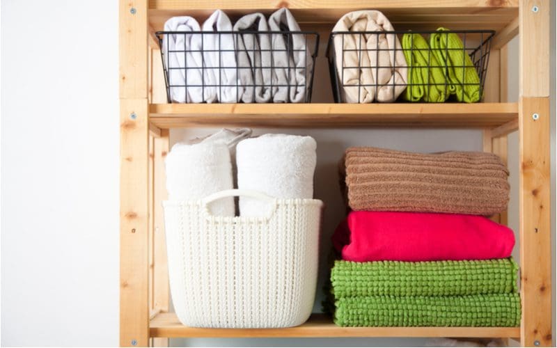 For a piece on dorm room ideas, a bunch of towels and baskets sit on wooden shelves