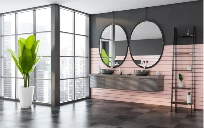 Photo of a modern and spacious oval bathroom mirror idea in a loft-style condo