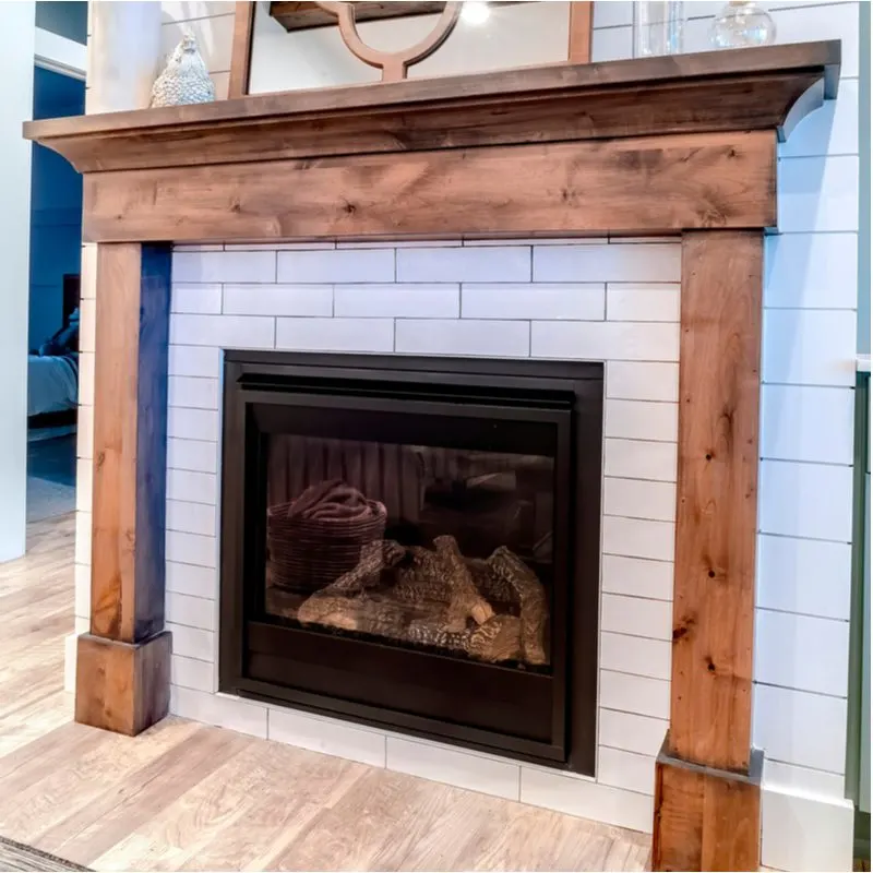 Fireplace tile idea featuring white subway tile framed by a simple wooden mantle