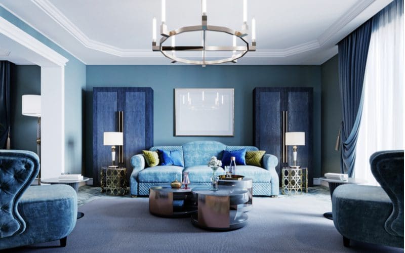 Light blue couch living room idea in a dark room with navy accents and furniture