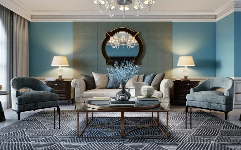 An idea to use mirrors as wall decor above a couch as shown in a blue painted room with modern furniture