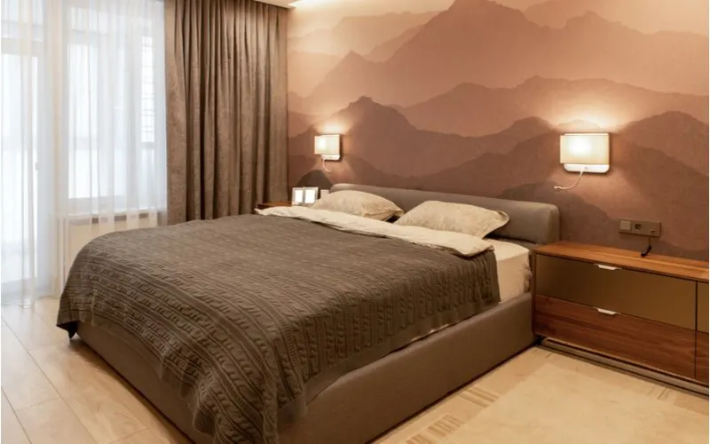 Grey bedroom idea with a mountainous-style wallpaper above the headboard
