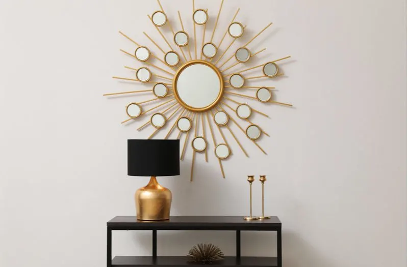 Boho style round gold and glass wire mirror for a piece on entry table decor