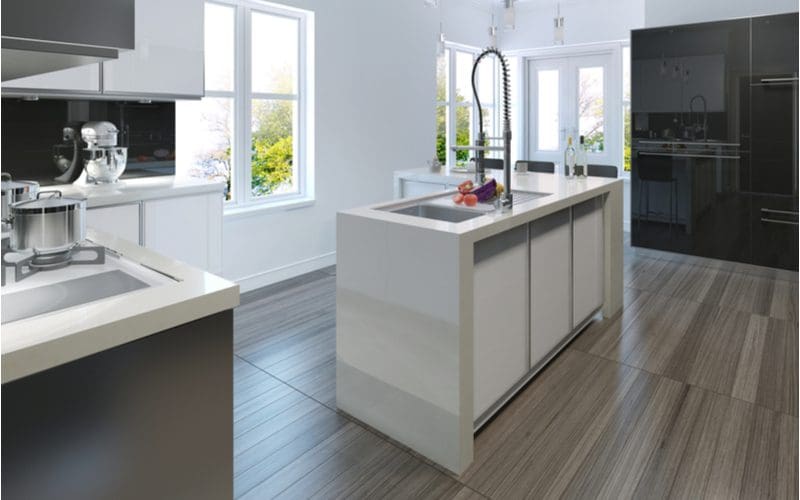 Image for a piece on what color cabinets with gray floors with a white cabinet with a chrome faucet with grey wood-look tile floors