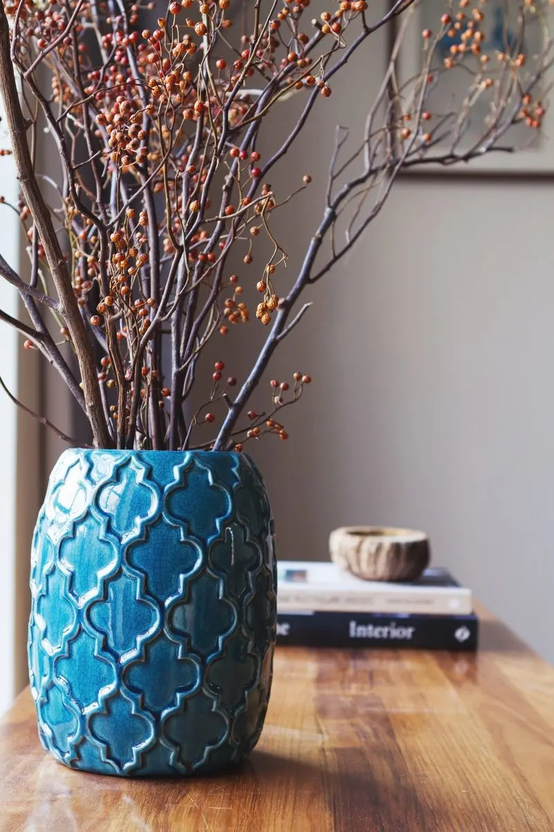 Blue teal vase diffuser with sticks poking out for a piece on teal bedroom ideas