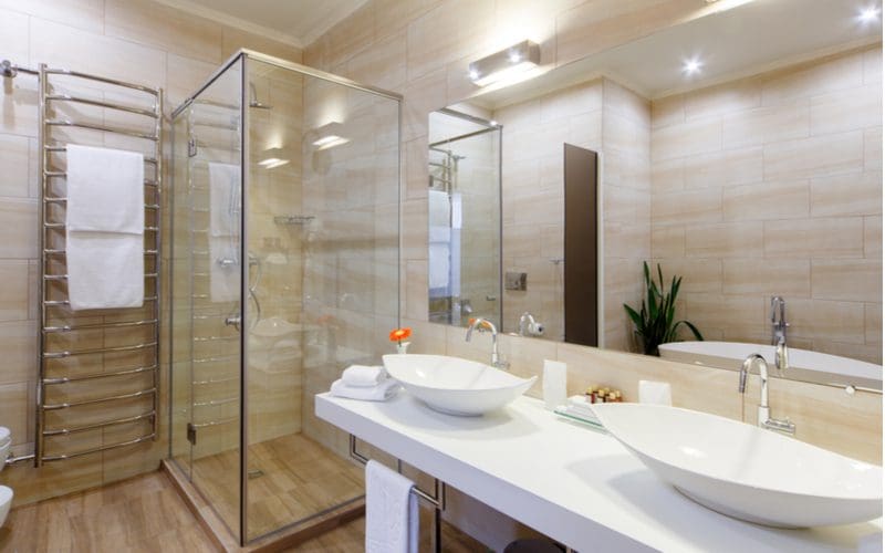 Image of a small bathroom with shower with tile-look wallpaper