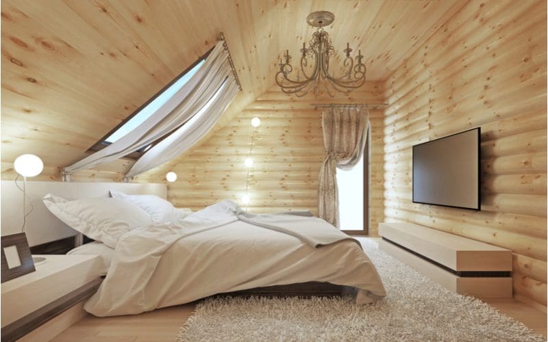 Cottage-style aesthetic bedroom idea with light wood paneled walls with simple lighter wood furniture