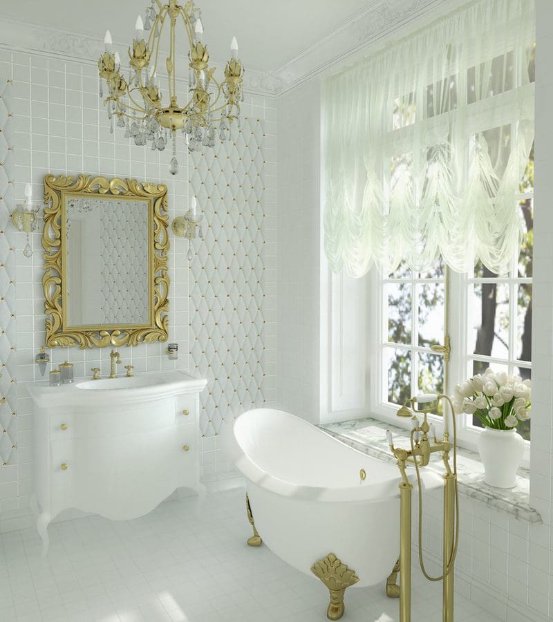 White bathroom, tile, and tub with gold fixtures, mirror, and chandelier