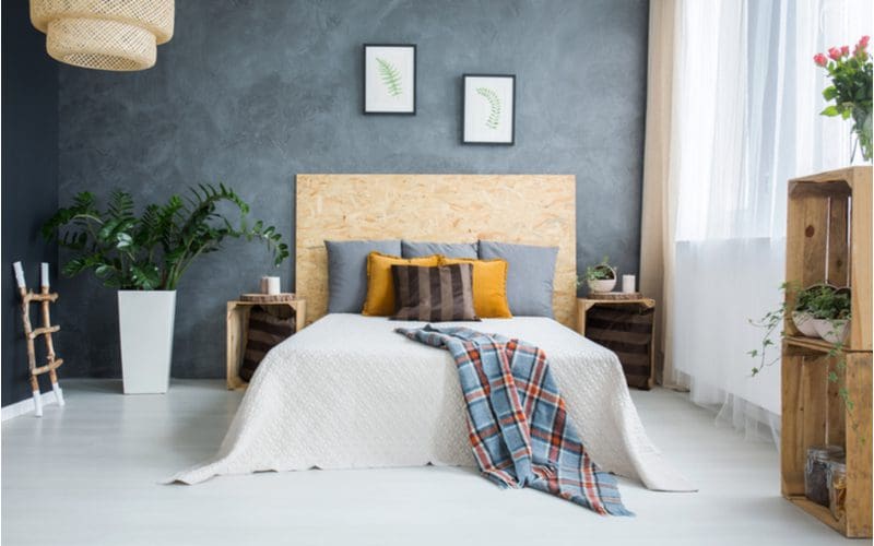 Piece on grey bedroom ideas featuring a rustic pallet and plywood furniture design with textured grey walls