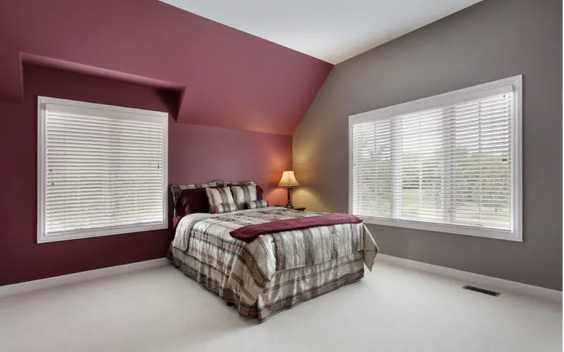 Deep maroon and grey bedroom idea with white carpet and white trim
