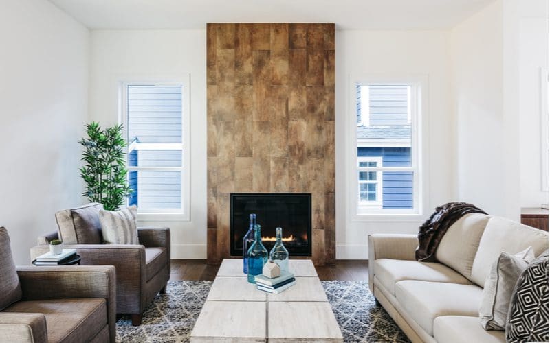 Fireplace tile idea featuring wood-look parquet tile framing the chimney with no mantle