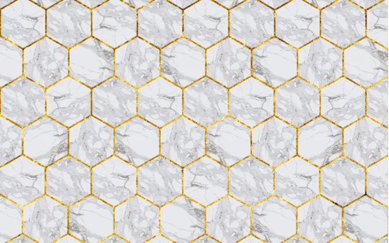 White hex tile backsplash with gold grout for a piece on white and gold bathroom ideas