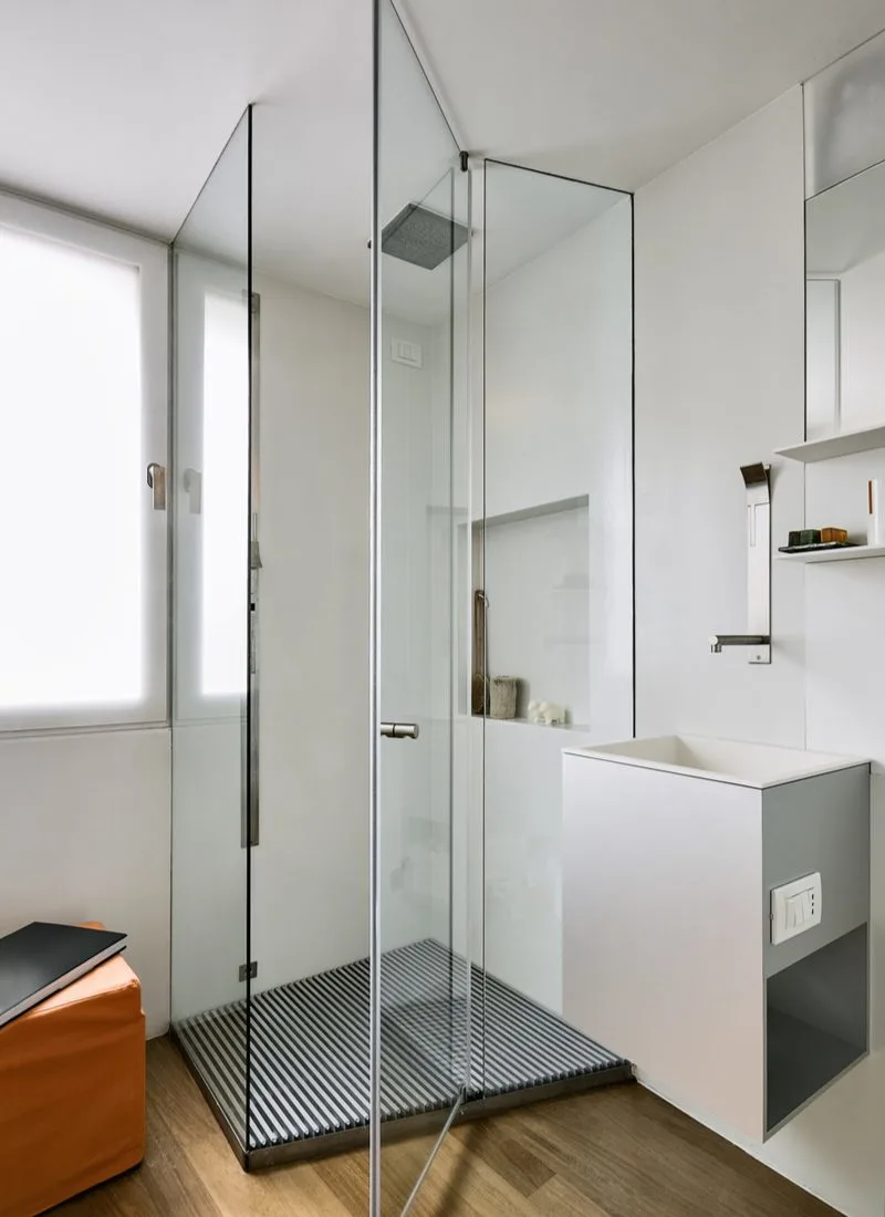 Image of a small bathroom idea with shower featuring glass walled shower and a very small wall-mounted sink