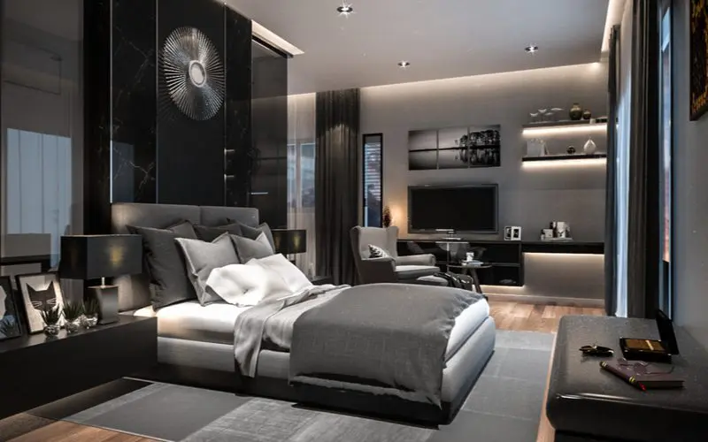 Dark grey bedroom idea with grey walls and dark black marble accents above the bed and on the side tables