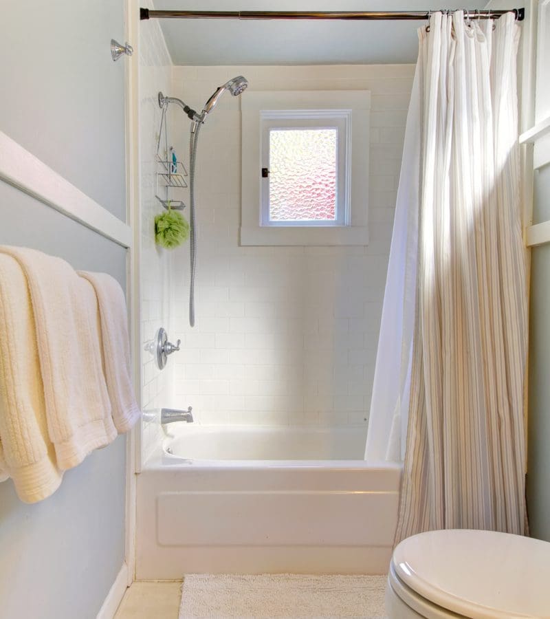 Piece on small bathroom ideas with showers featuring a simple vinyl tub surround with a white curtain to make the room look bigger