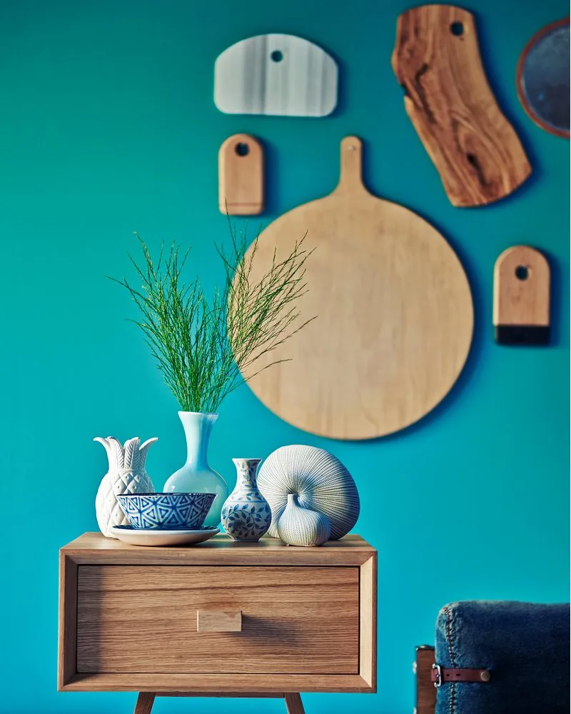 Cutting Boards hanging on a teal wall for a piece on kitchen wall décor ideas