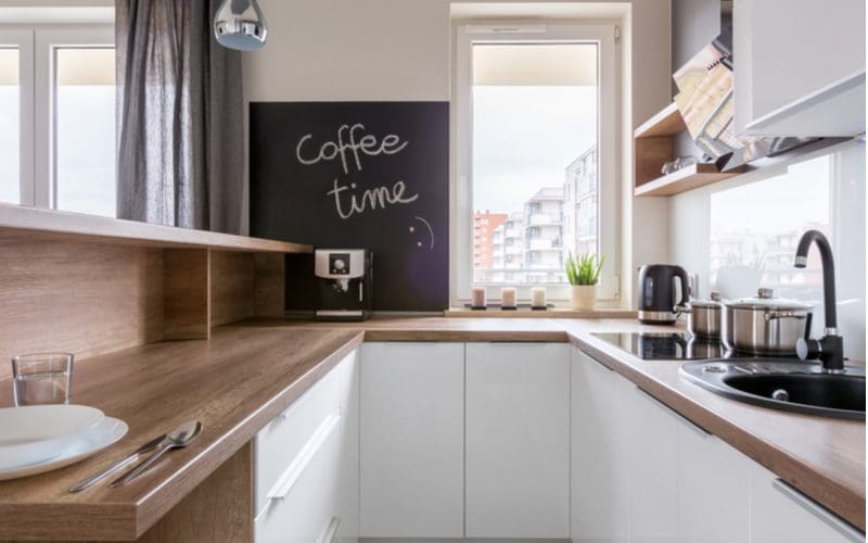 Kitchen wall decor ideas featuring a square chalkboard that says coffee time on the wall