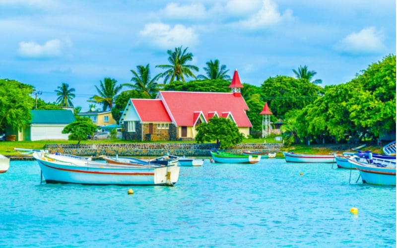 Image of a red roof with yellow paint overlooking a gorgeous blue water bay