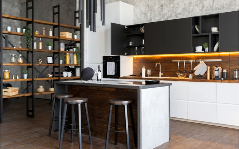 Industrial styling idea titled Go for Function with a loft-style home making good use of white cabinets, metals, and natural wooden flooring and shelves