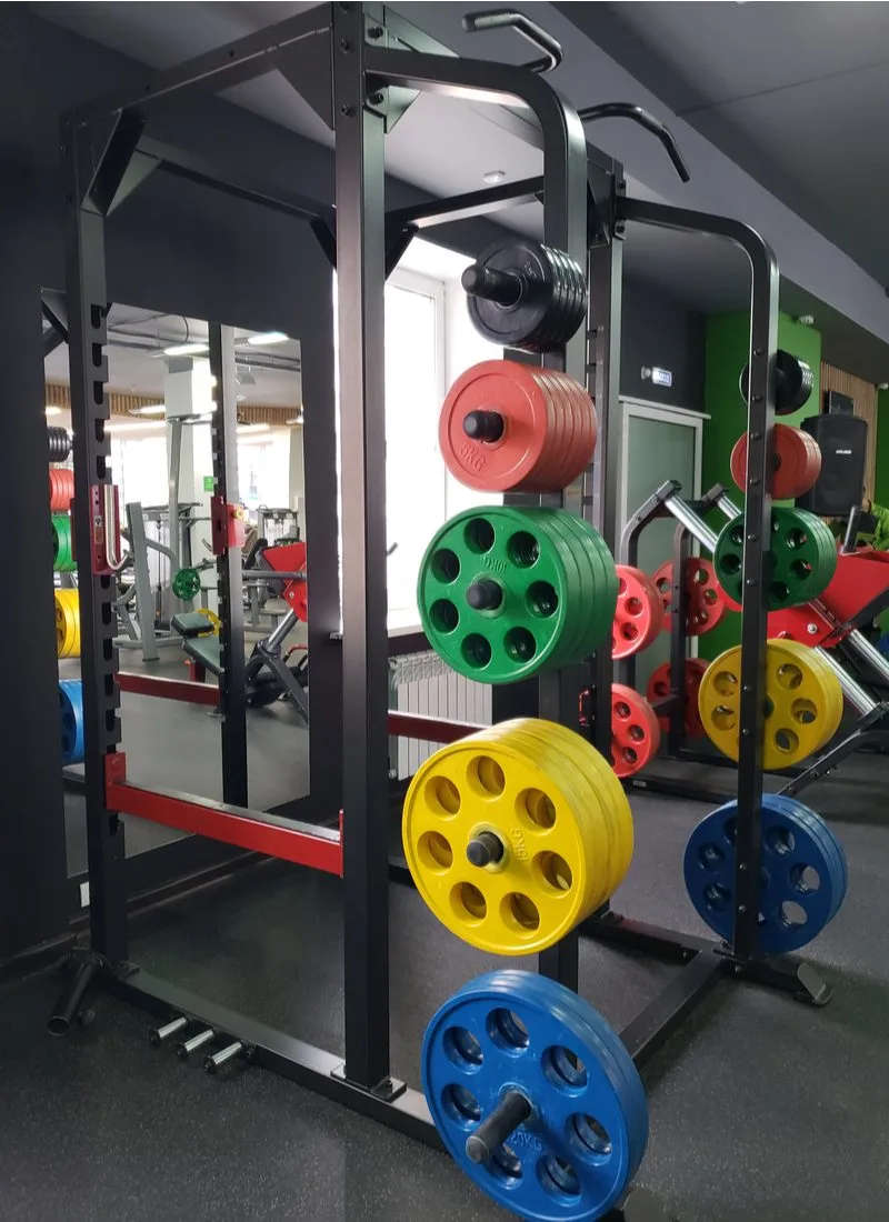 For a piece on small home gym ideas, a number of colored weights racked up on a vertical metal rack