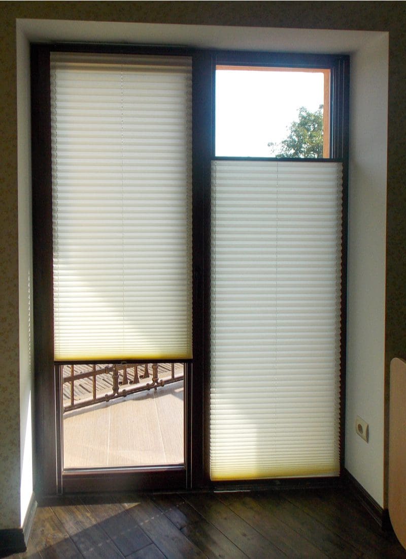 Honeycomb Shades used as a window treatment for sliding glass doors as pictured in a vertical image