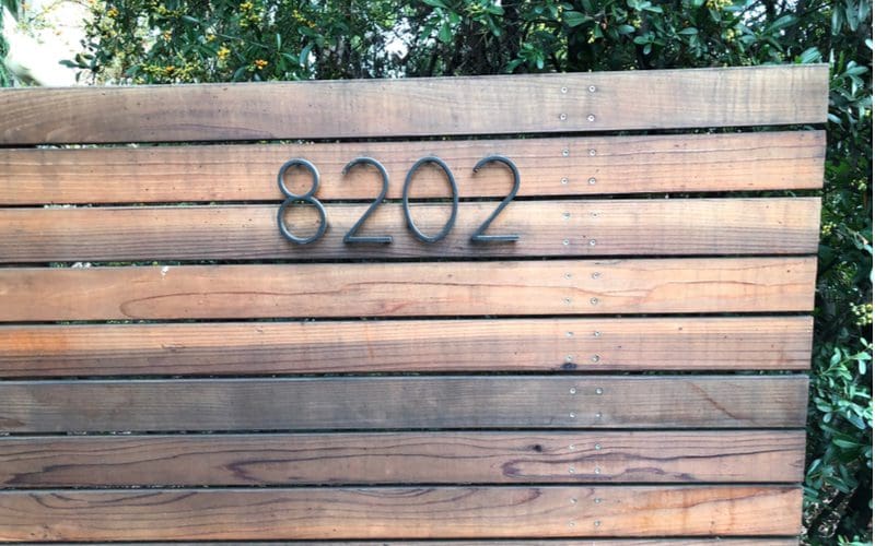 House number idea featuring metal numbers on a wooden slatted wall