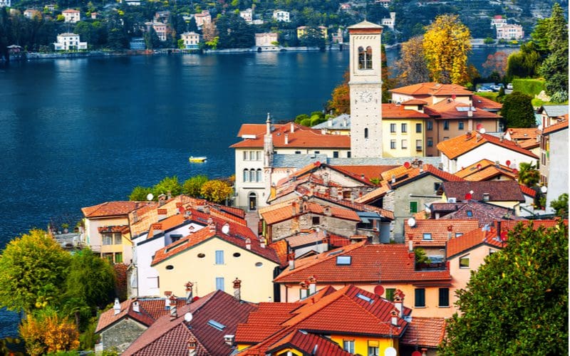 A bunch of homes in Lake Como, Italy with red roofs in various paint colors