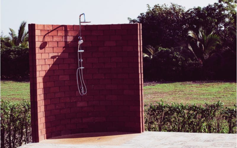Outdoor Brick Shower for a very simple outdoor doorless walk-in shower idea