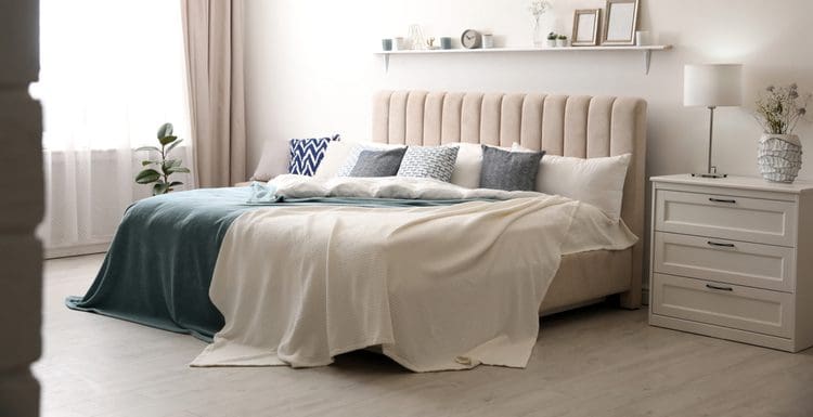 Complete guide titled Parts of a Bed featuring a fully assembled bed with a tan fabric sleigh-type headboard in a white boho-style room