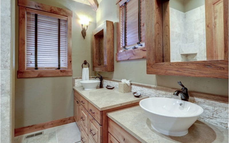Modern rustic bathroom idea with natural grey stained pine wood with dark fixtures and stone backsplash