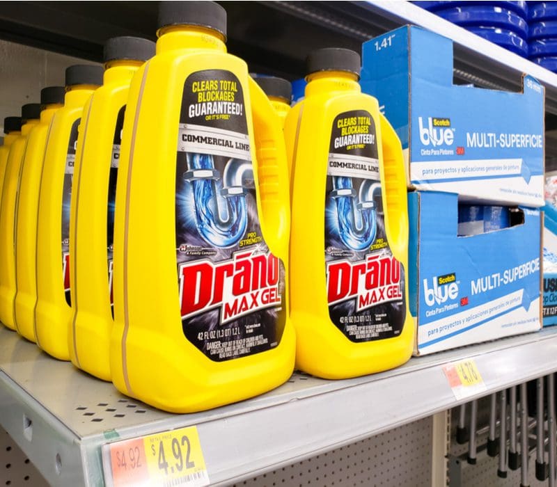 Photo of a drano bottle showing why you should never put it in a dishwasher while the bottle sits on a shelf