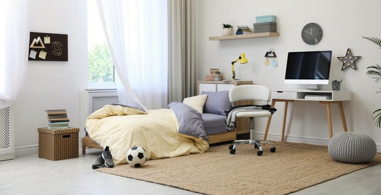Featured image for a style roundup titled Teen Boys Room Decorating Ideas featuring a sports-themed room with a soccer ball and white walls
