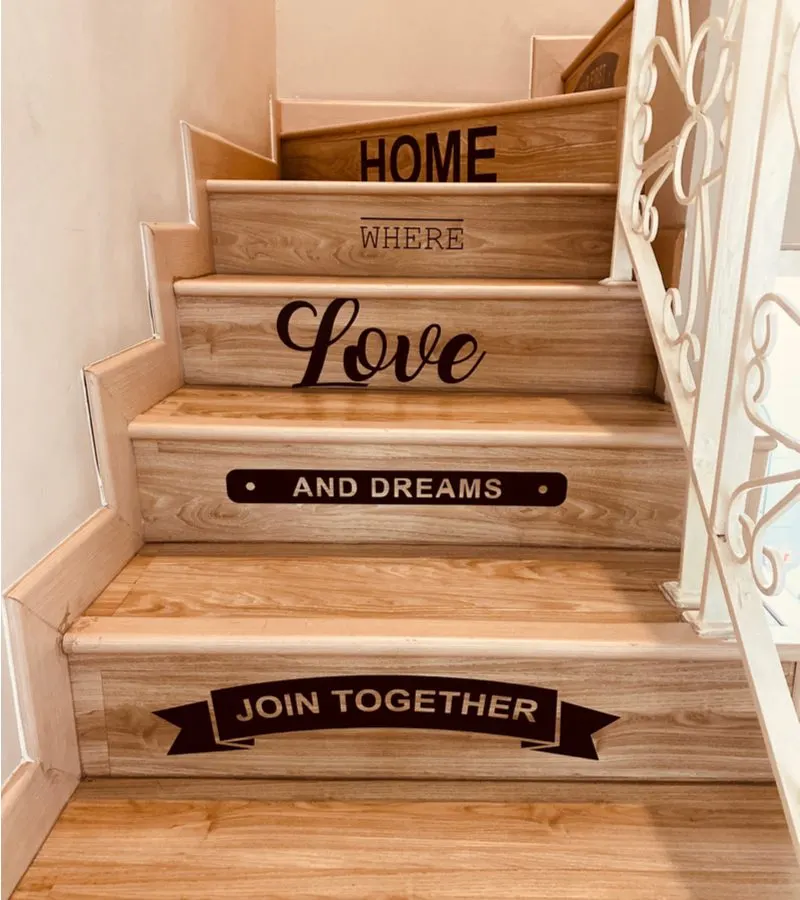 Inspirational phrase decals attached to the end of some stairs for a piece on decorating ideas for stairs