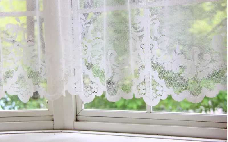 Image of a bay window curtain idea in white sheer lace that's best for a vintage-style home