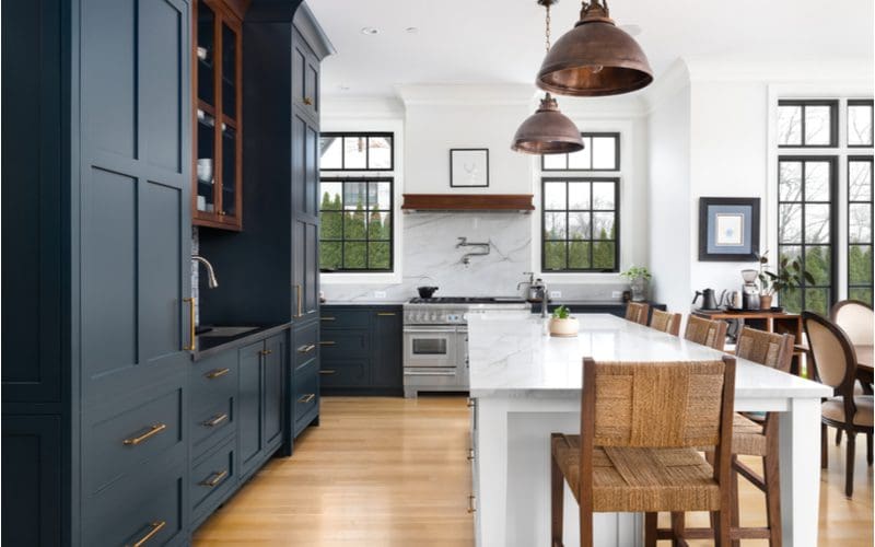 Dark black painted cabinets that blend really well with the natural pine wood floors