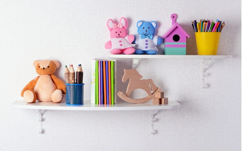 Living room toy storage idea made of rustic-style floating shelves